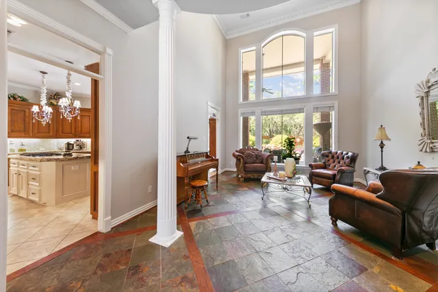a living room with furniture and large windows