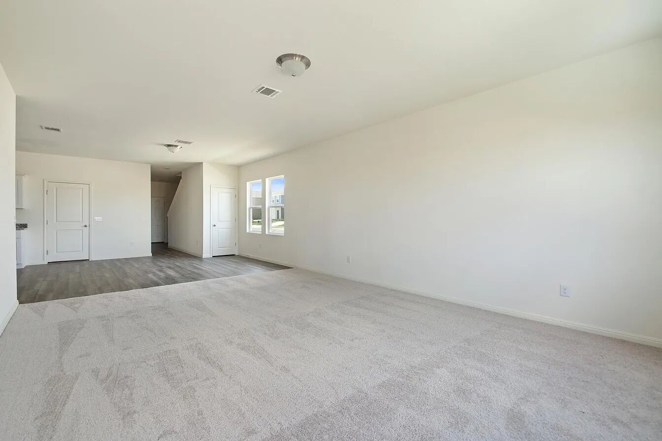 101 Aoudad Road Hutto, TX 78634 - Photo 15 of 39 Sun-filled open-concept living space with pristine carpeting and sleek hard flooring.
