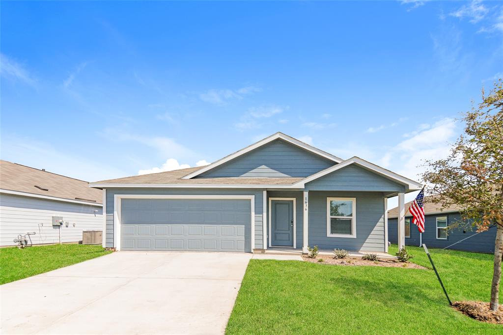 a front view of a house with a garden and yard