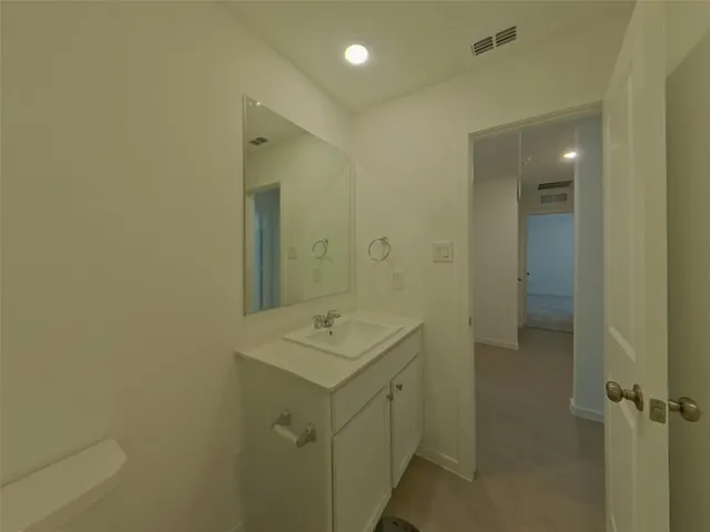 a bathroom with a shower sink and mirror