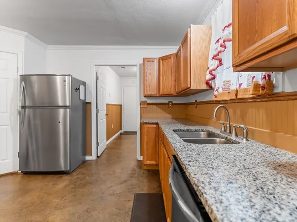 a kitchen with refrigerator and cabinets