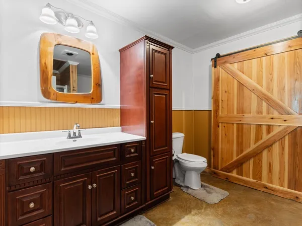 a bathroom with a sink a toilet and a shower