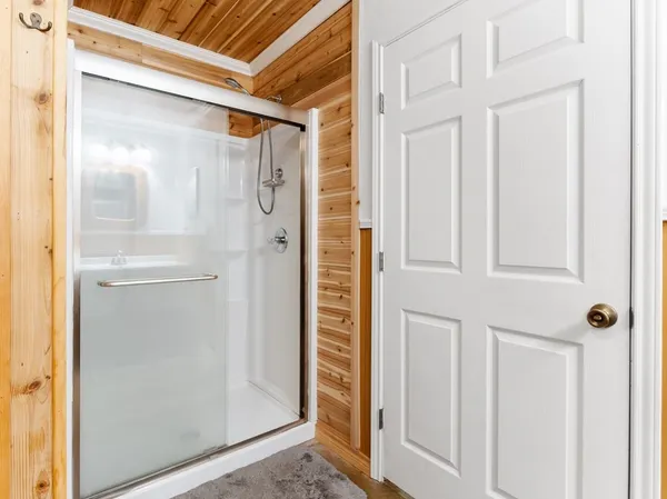 a bathroom with a toilet and a shower