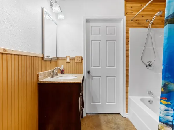 a bathroom with a toilet a sink and shower