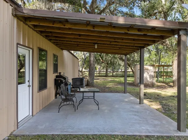 a view of a house with a backyard porch and sitting area