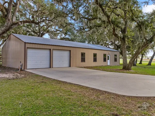 a front view of house with yard and trees