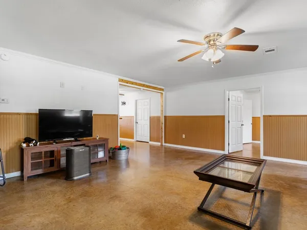 a view of a livingroom with furniture and a flat screen tv