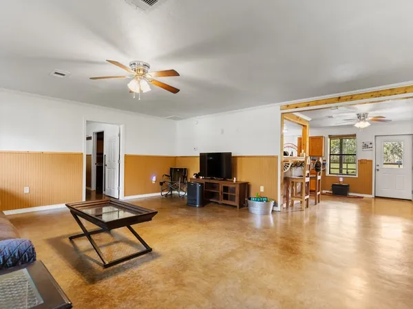 a living room with furniture and kitchen view