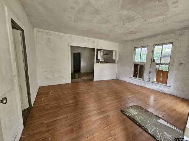 wooden floor in an empty room with a fireplace