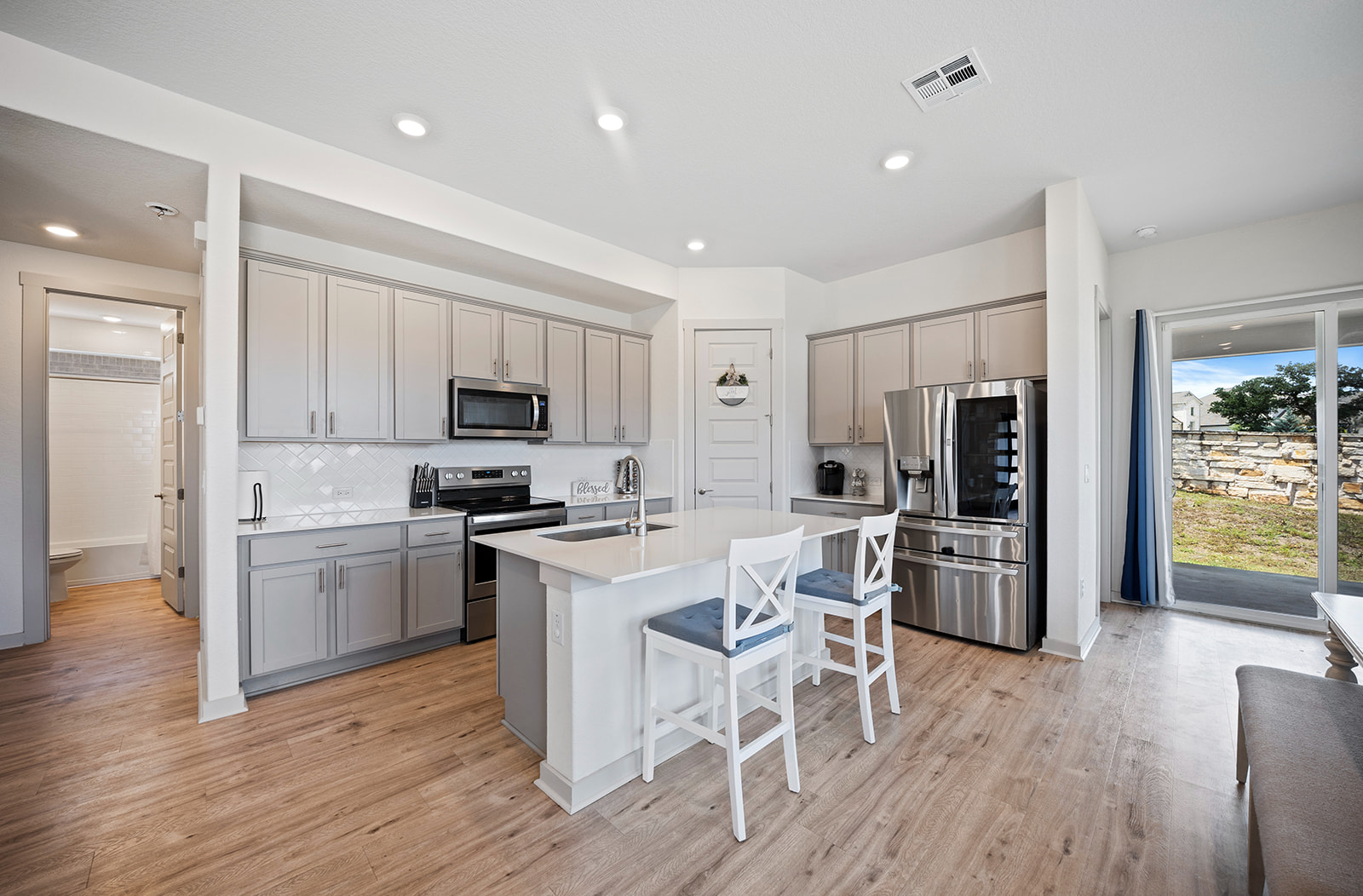 900 Balsora Cove Georgetown, TX 78628 - Photo 6 of 39 Culinary delights await in this bright kitchen with a spacious island, perfect for entertaining.