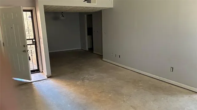 an empty room with a fireplace and a window