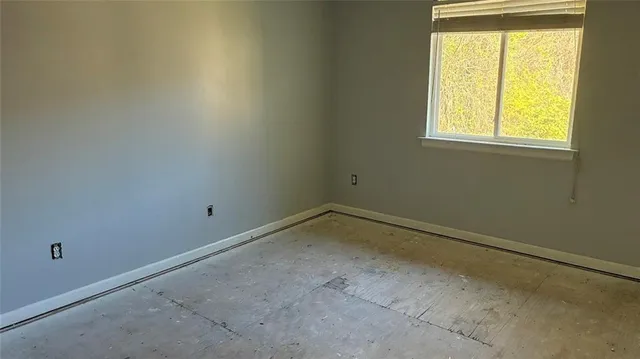 a view of walk in closet with empty room