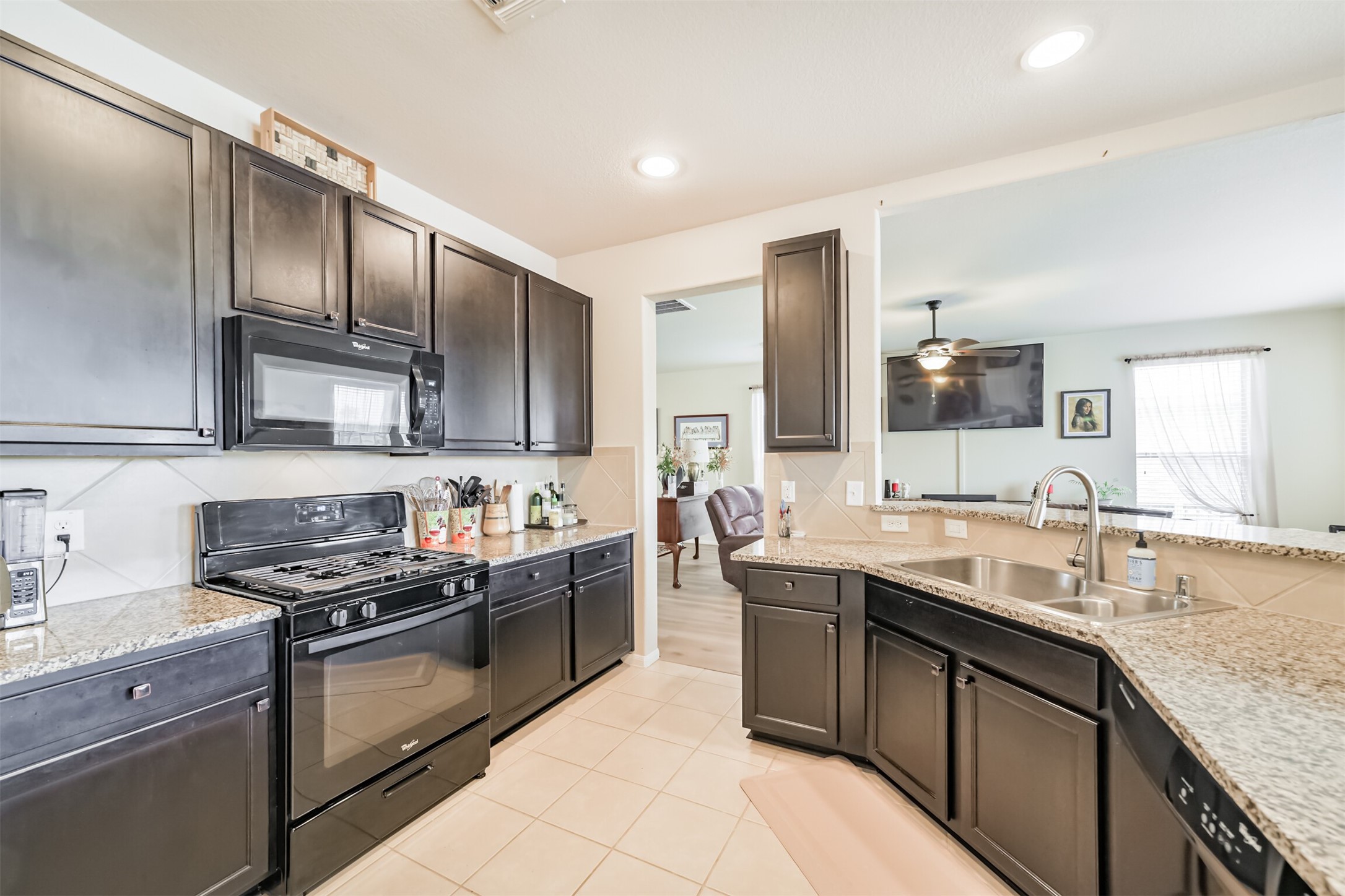 12009 La Salle River Road Conroe, TX 77304 - Photo 13 of 50 a kitchen with stainless steel appliances granite countertop a sink stove and refrigerator
