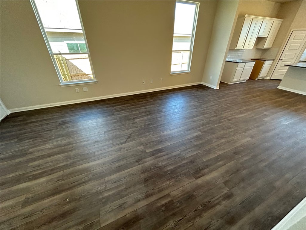 2204 Johnny Lyon Court Bryan, TX 77807 - Photo 2 of 10 an empty room with wooden floor and windows