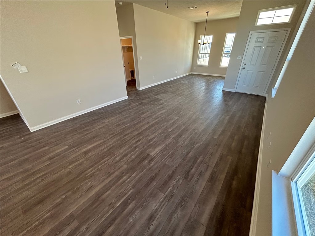 2204 Johnny Lyon Court Bryan, TX 77807 - Photo 3 of 10 a view of an empty room with wooden floor and a window