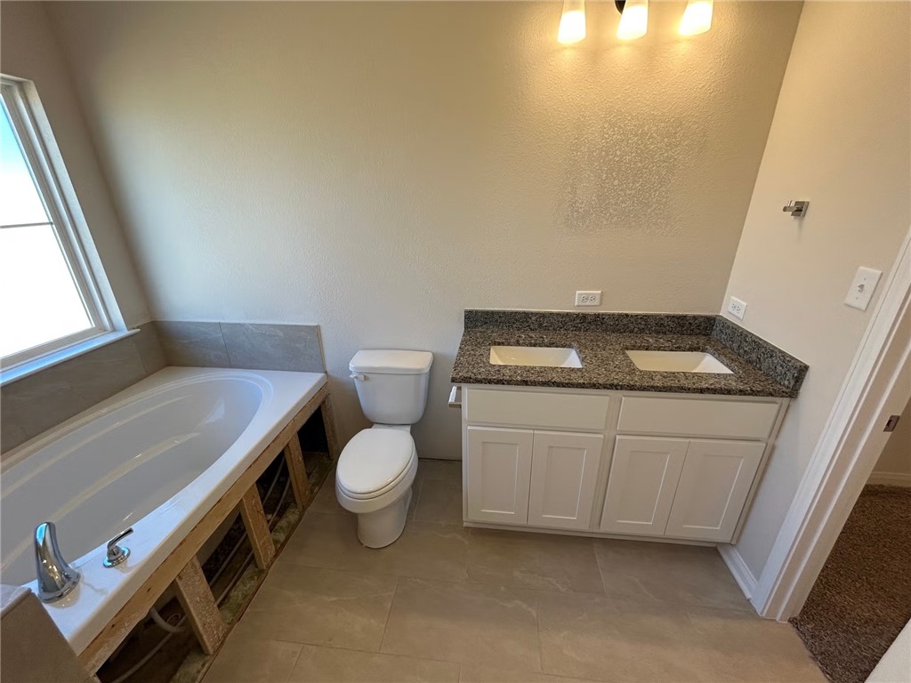 2204 Johnny Lyon Court Bryan, TX 77807 - Photo 8 of 10 a bathroom with a toilet and a sink