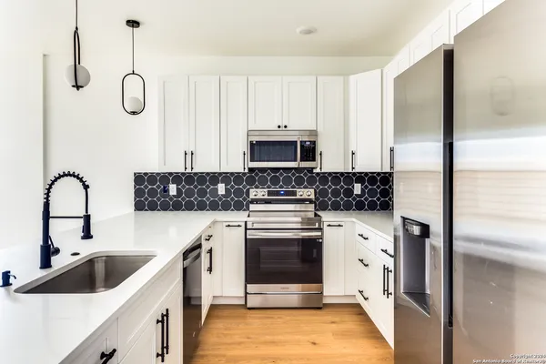 a kitchen with a sink cabinets and stainless steel appliances