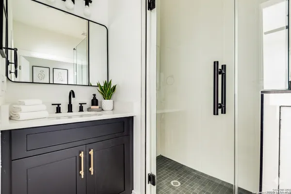 a bathroom with a sink and mirror