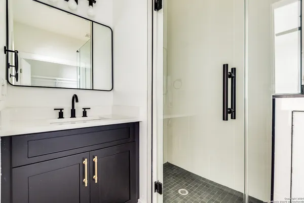 a bathroom with a sink vanity and mirror