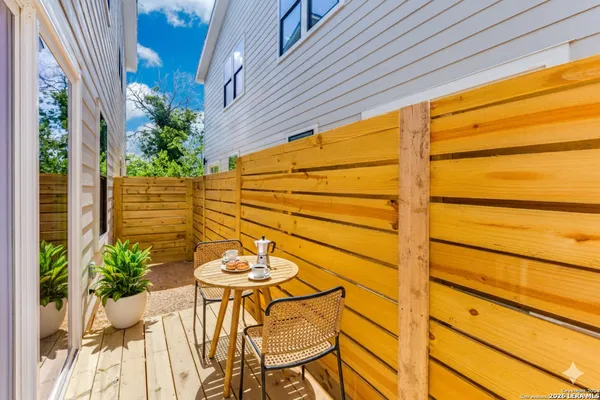 a view of a patio with table and chairs and potted plants