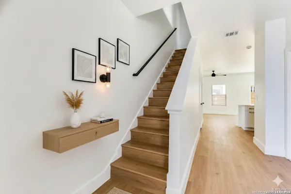 a view of entryway and hall with wooden floor