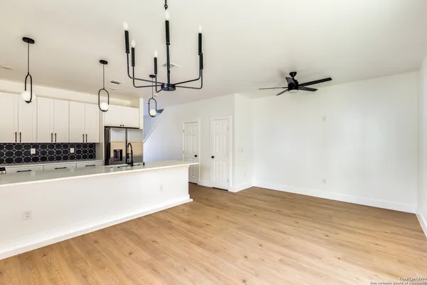 a view of a kitchen with wooden floor