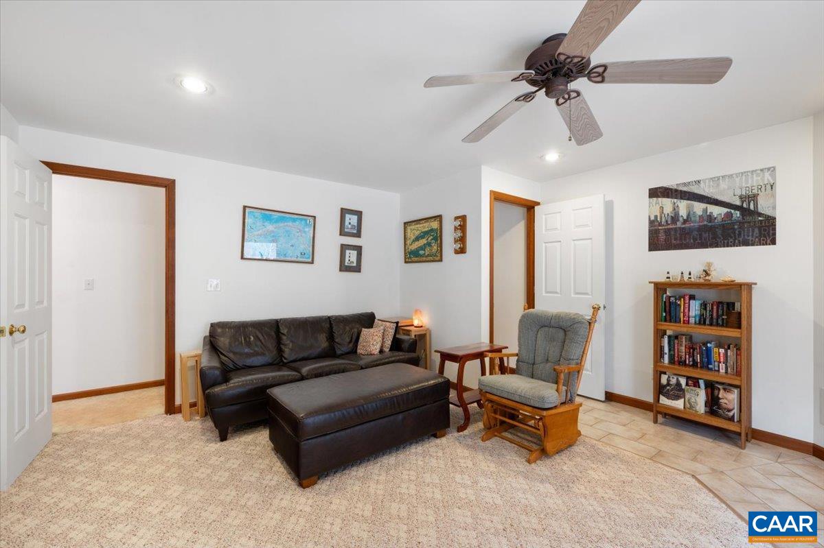 1411 Hill Hollow Road Faber, VA 22938 - Photo 22 of 50 a living room with furniture and a book shelf