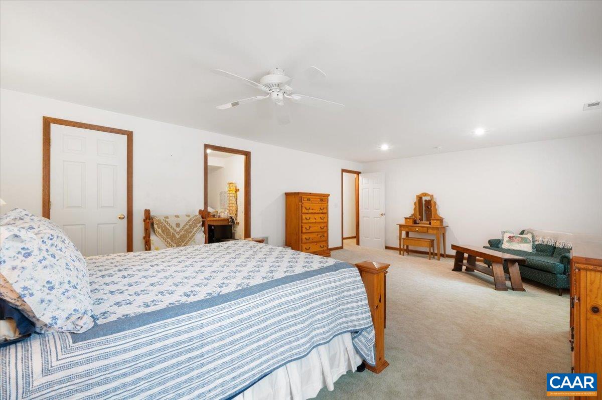 1411 Hill Hollow Road Faber, VA 22938 - Photo 24 of 50 a bedroom with a bed and a chandelier