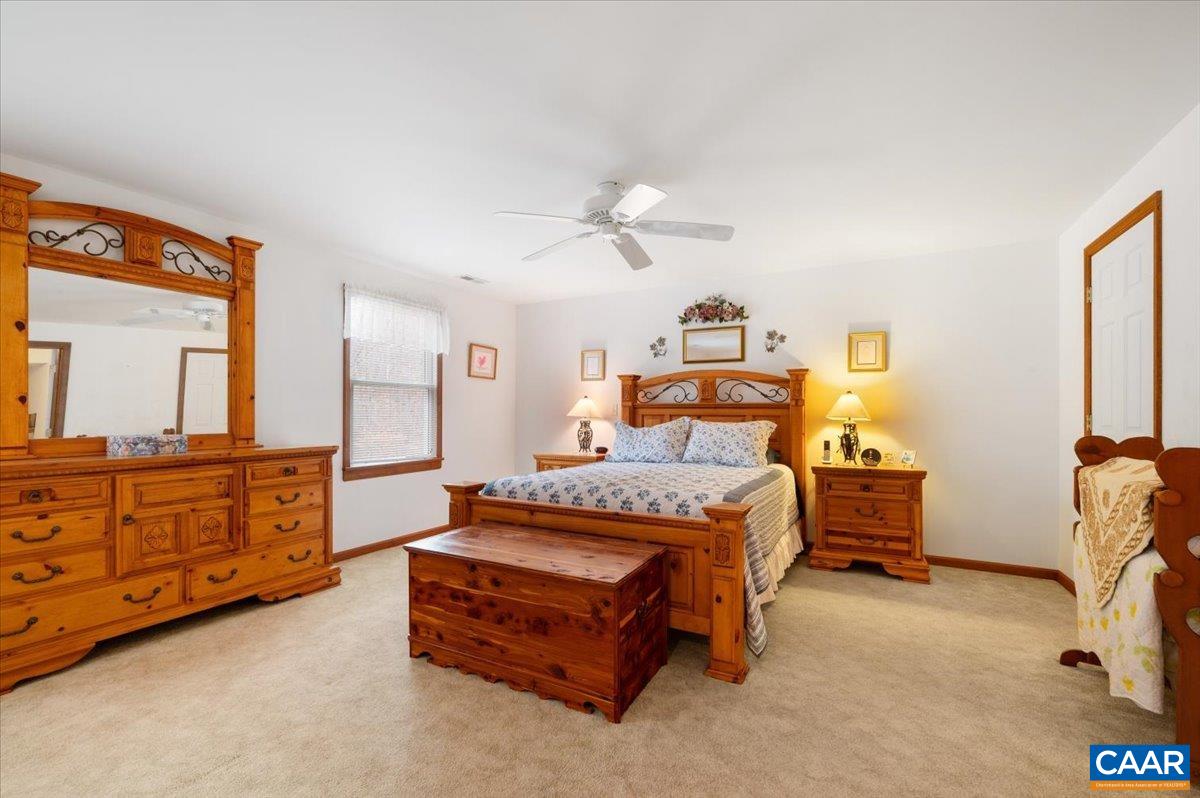 1411 Hill Hollow Road Faber, VA 22938 - Photo 26 of 50 a bedroom with a bed and a chandelier fan