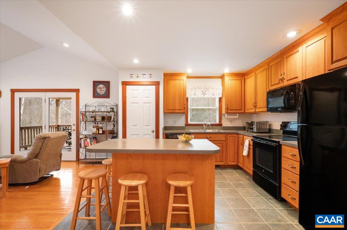 1411 Hill Hollow Road Faber, VA 22938 - Photo 10 of 50 a large kitchen with kitchen island granite countertop a large counter top stainless steel appliances a stove a sink and cabinets