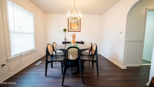 a dining room with furniture and wooden floor
