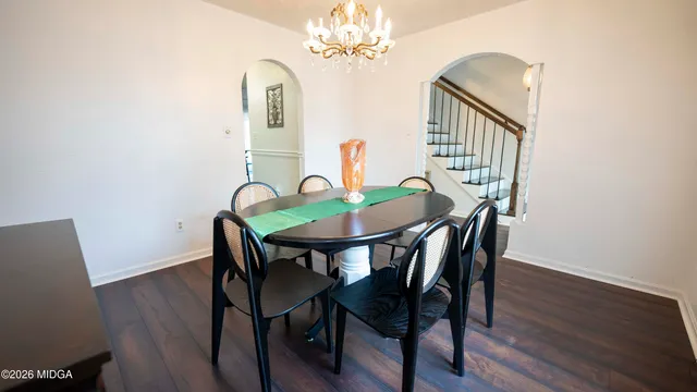 a view of a dining room with furniture and wooden floor