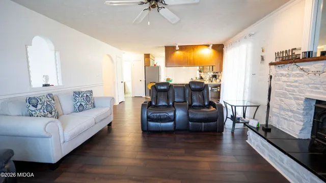 a living room with furniture and a fireplace