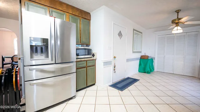 a kitchen with stainless steel appliances granite countertop a refrigerator and a stove