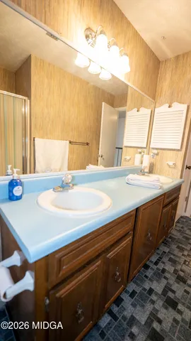 a bathroom with a sink a vanity and a large mirror