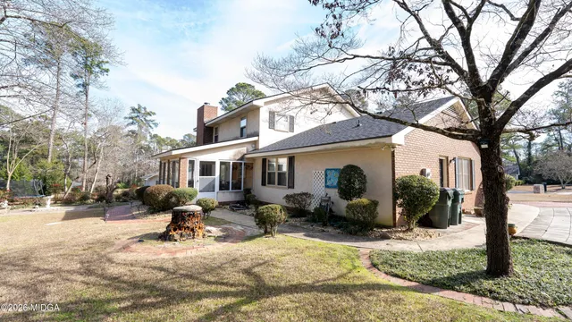 a view of a house with a yard covered in snow