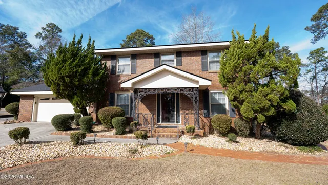 a front view of a house with garden