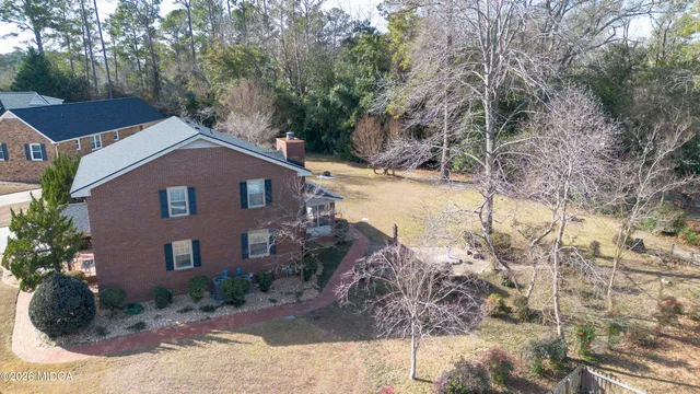 a house with trees in the background