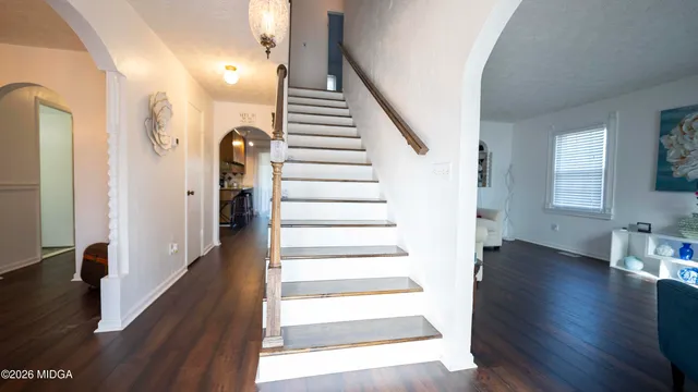 a view of entryway and hall with wooden floor