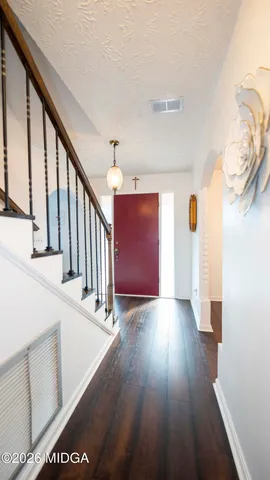 a view of entryway with wooden floor