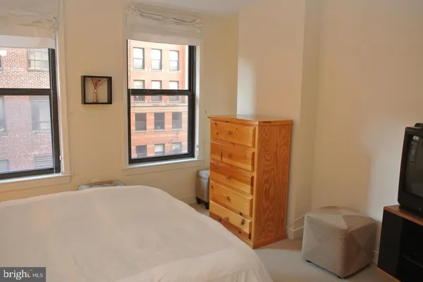 a bedroom with a bed and furniture