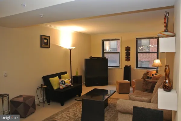 a living room with furniture and a lamp