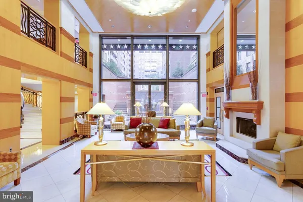 a view of a living room with a table and chairs