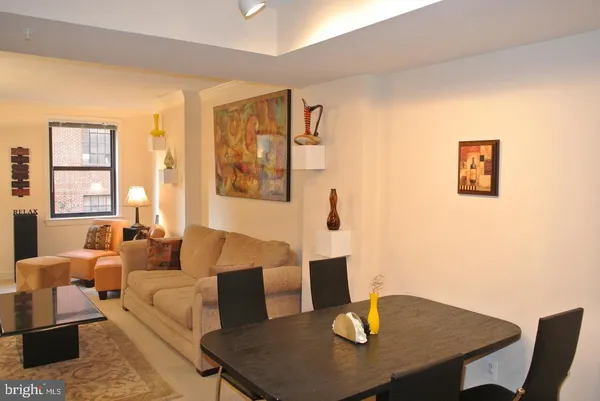 a living room with furniture wooden floor and a table