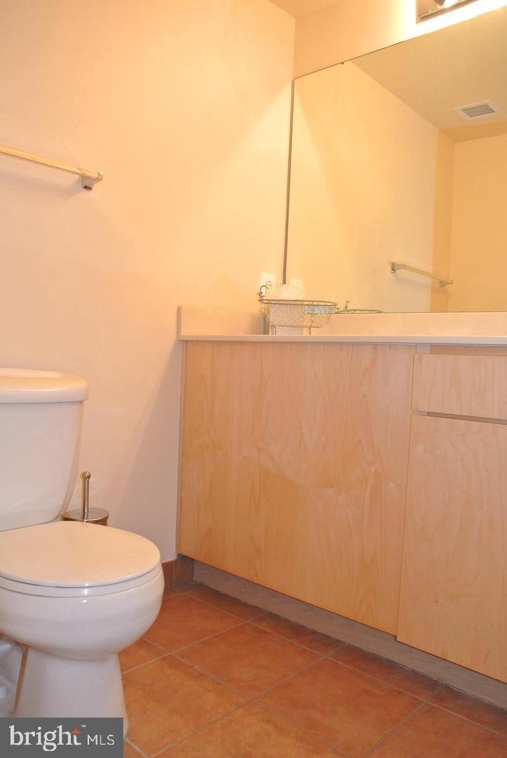 616 E Street Northwest, Unit 447 Washington, DC 20004 - Photo 9 of 28 a bathroom with a toilet and a sink