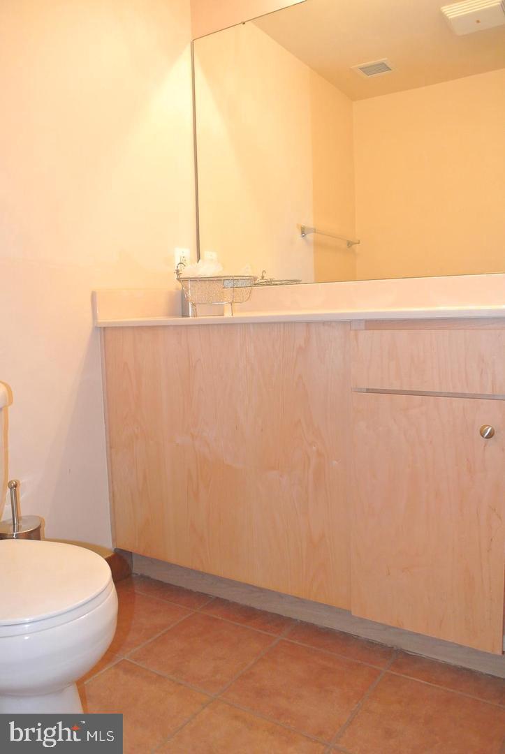616 E Street Northwest, Unit 447 Washington, DC 20004 - Photo 10 of 28 a bathroom with a toilet and a vanity