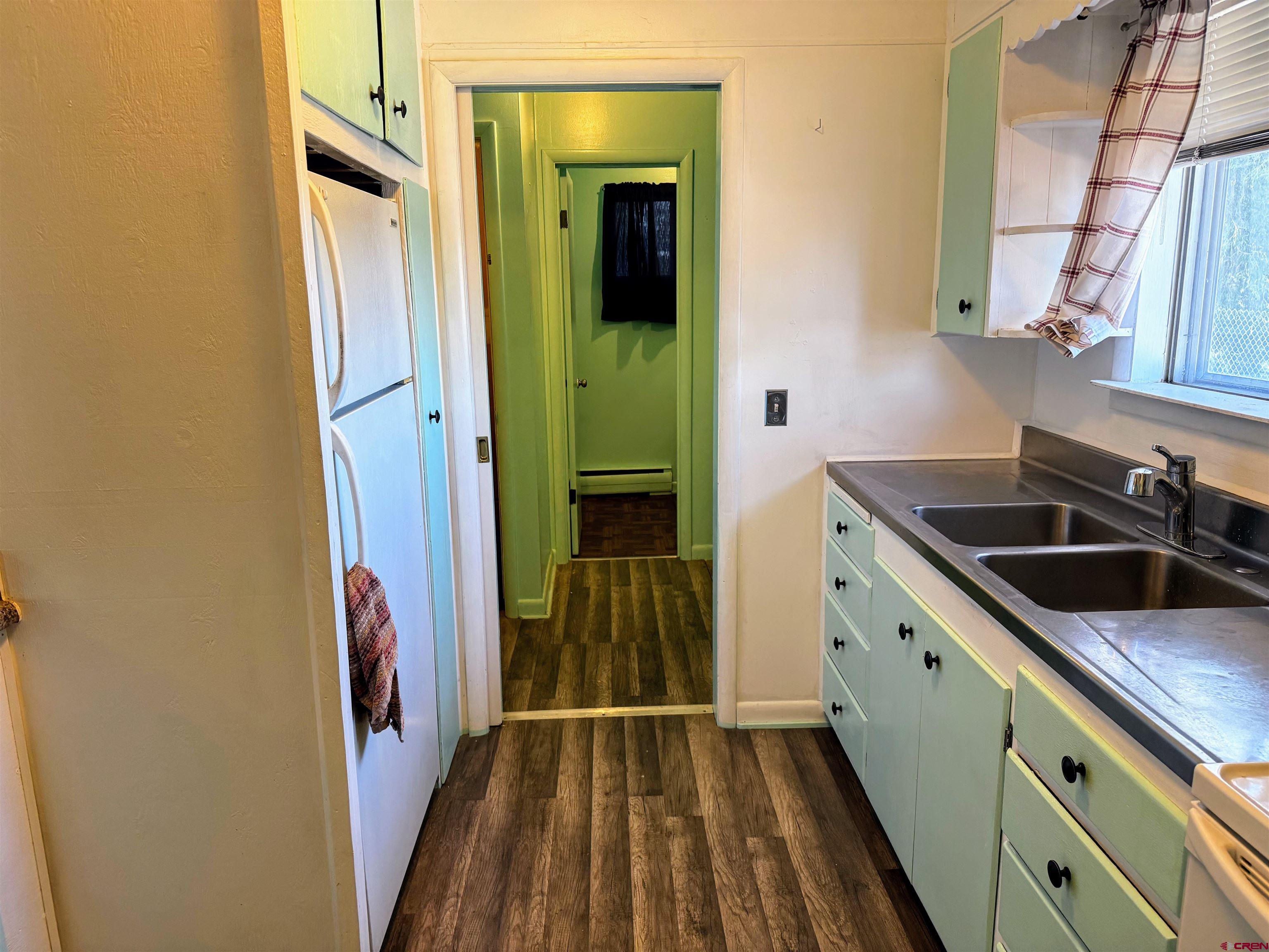 20114 Austin Road Austin, CO 81410 - Photo 11 of 26 a kitchen with a sink and cabinets