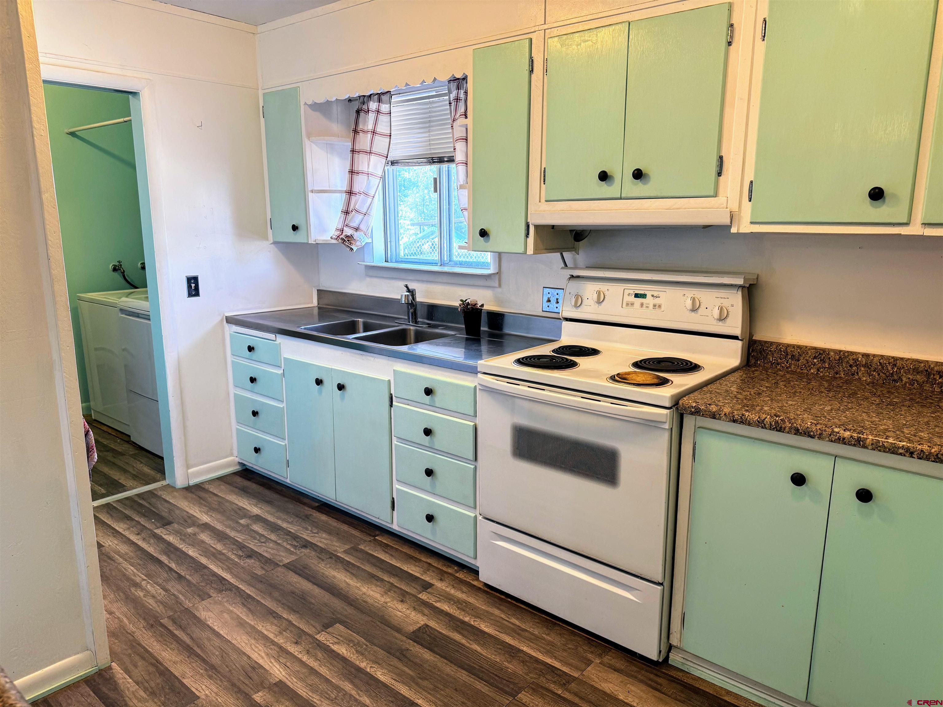 20114 Austin Road Austin, CO 81410 - Photo 12 of 26 a kitchen with granite countertop a stove sink and cabinets