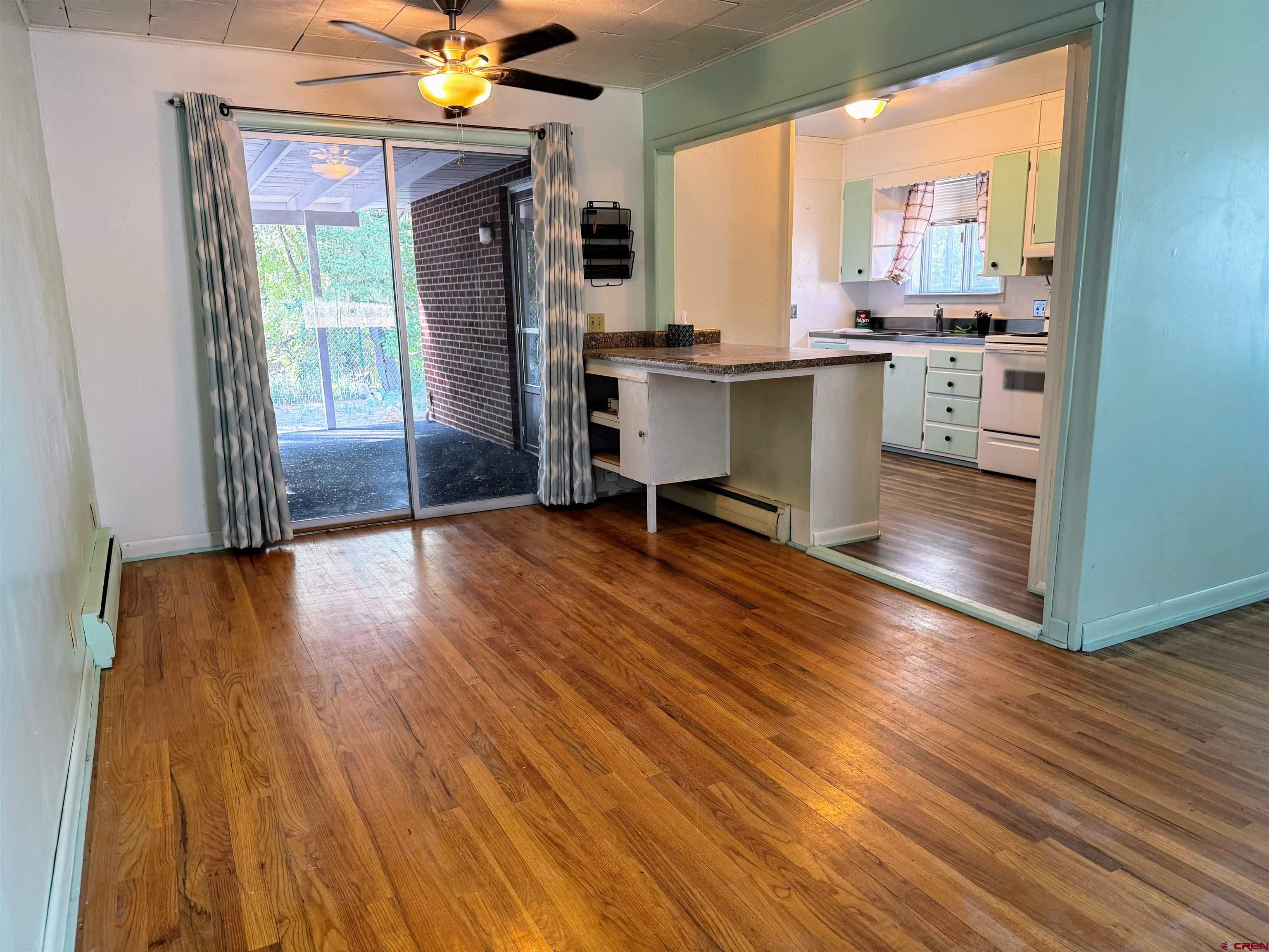 20114 Austin Road Austin, CO 81410 - Photo 13 of 26 a view of a dining room with furniture window and wooden floor
