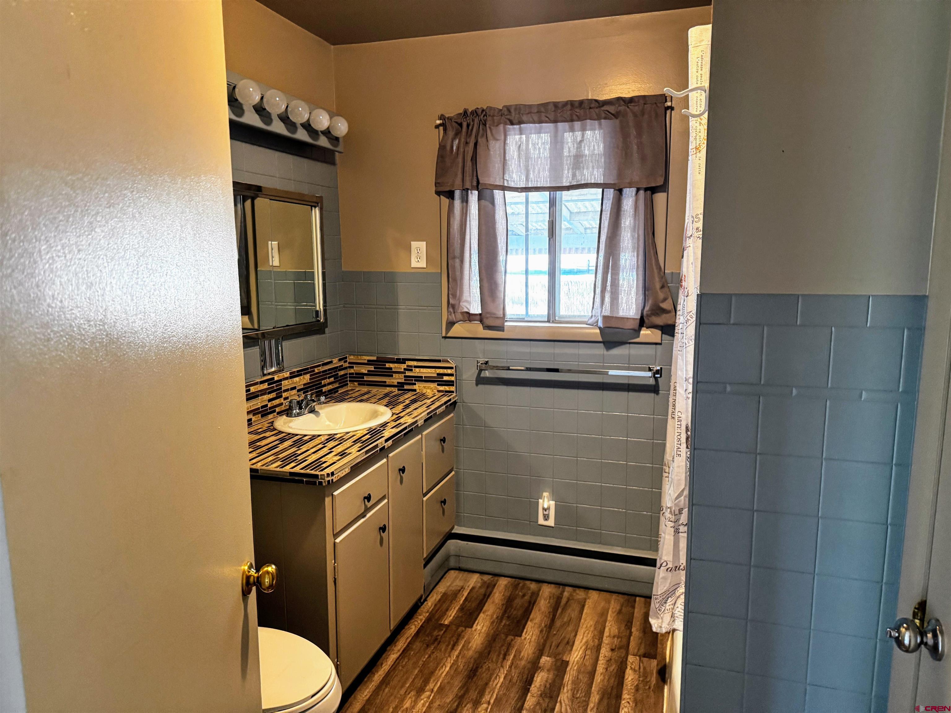 20114 Austin Road Austin, CO 81410 - Photo 15 of 26 a bathroom with a granite countertop sink toilet and shower